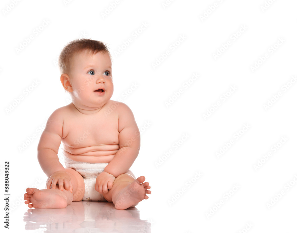 Attentive infant child baby boy in a diaper sitting on a white background. Attentive infant child baby boy in a diaper sitting on a white background.