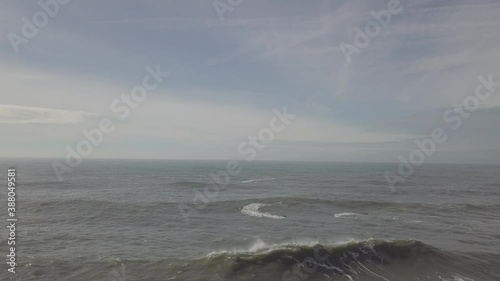 Aerial view of two persons driving a jet motorboat along the Portuguese coastline, Portugal.