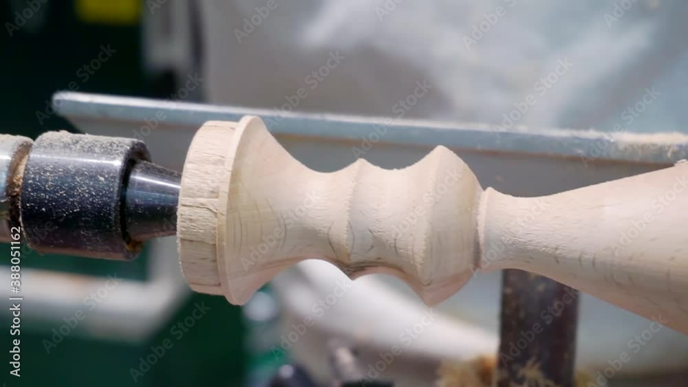 wooden part rotates on a lathe and is processed with a special tool. close-up wooden part rotates on a lathe and is processed with a special tool. close-up