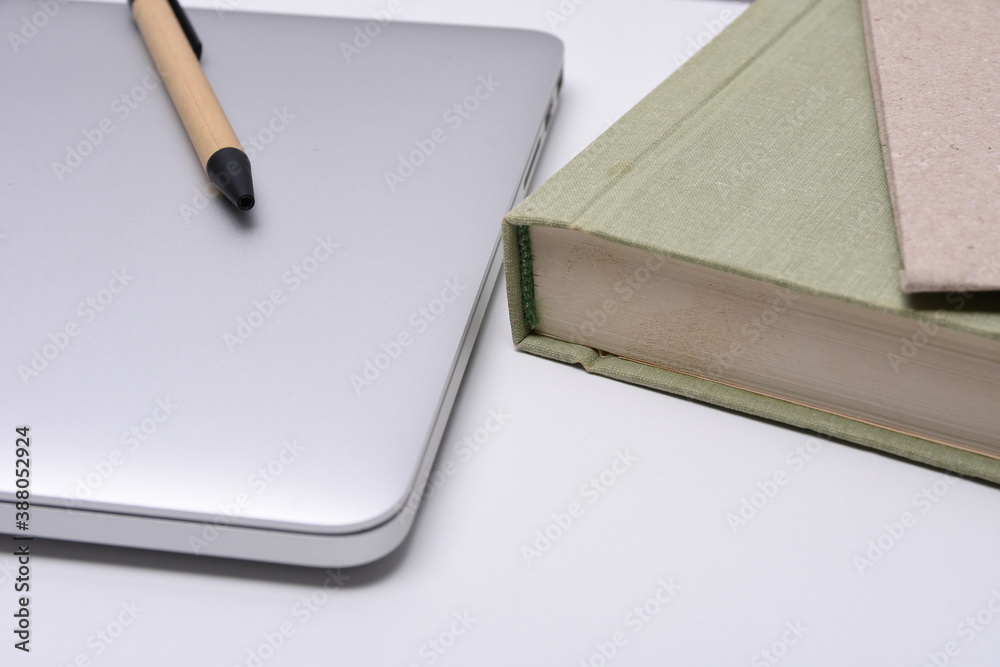 Desk with laptop, books and business pen Desk with laptop, books and business pen