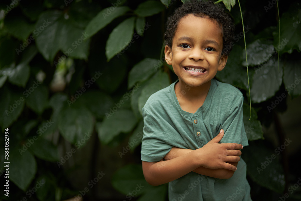 portrait of adorable black child boy near plants, african kid boy look at camera and smile, in the forest portrait of adorable black child boy near plants, african kid boy look at camera and smile, in the forest