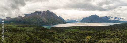 Panoramic View of Scenic Lake surrounded by Forest and Mountains in Canadian Nature. Aerial Drone Shot. Yukon, Canada.