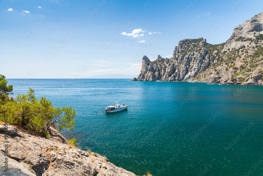 Pleasure boat with swimming tourists, Crimea
