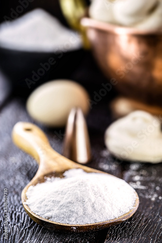 Fototapeta Naklejka Na Ścianę i Meble -  rustic wooden spoon with sugar, dose of sugar used in cooking, rustic kitchen