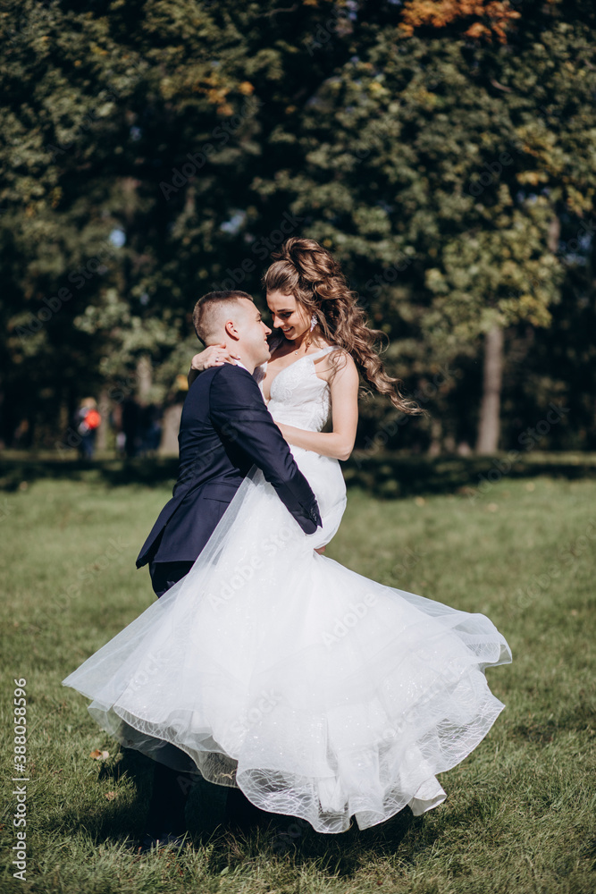 Walk of the bride and groom in the summer garden. Walk of the bride and groom in the summer garden.