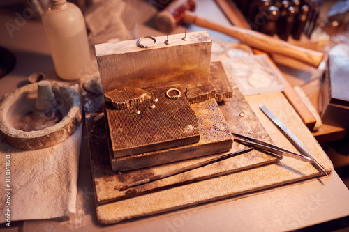 Close Up Of Jewellers Workbench With Tools And Designs In Studio
