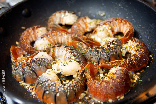 Cooking Lobster tails with garlic butter. Selective focus.
