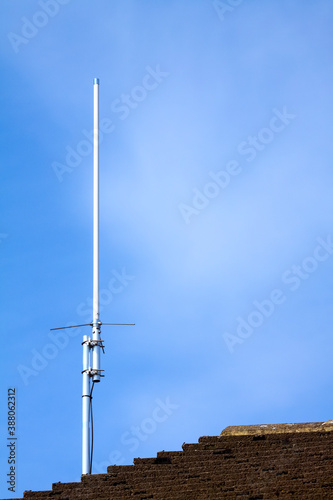 Diamond X30 2 Metre/70cm dual band amateur radio antenna aerial mounted on the side gable end of a house photo