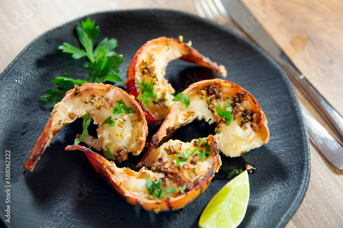Canvas Print Grilled lobster tails with garlic herbs butter on elegant black plate