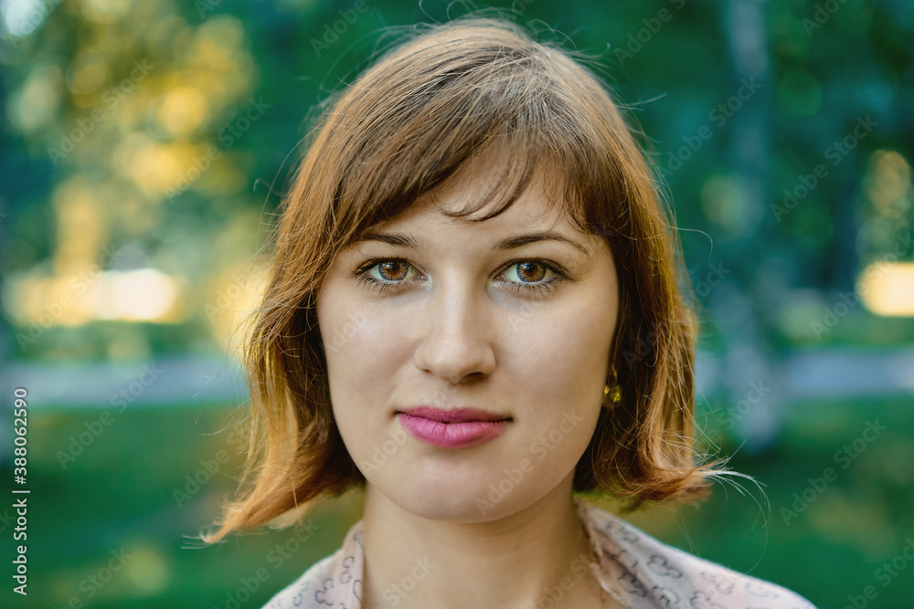 Fototapeta premium Attractive caucasian young woman outdoors with selective focus.