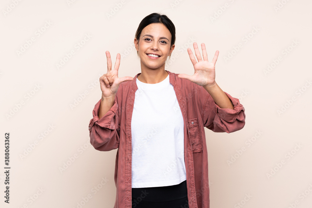Woman over isolated background counting eight with fingers Woman over isolated background counting eight with fingers
