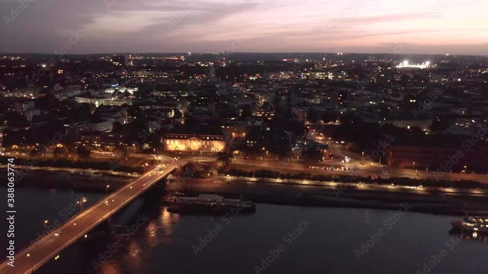 Wide drone circle shot around the City entrance of Mainz Germany right at magic hour showing the old bridge and the city center in the background Wide drone circle shot around the City entrance of Mainz Germany right at magic hour showing the old bridge and the city center in the background