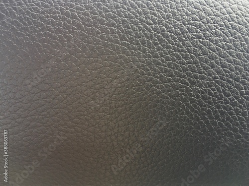 Textured beige grey leather background with convex cells.