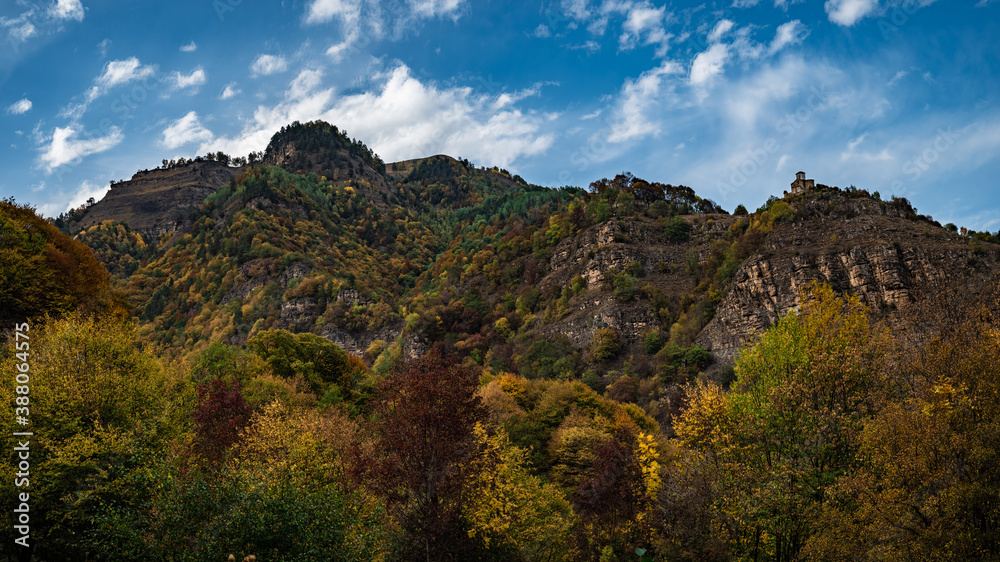 Bright autumn in mountains and blue sky