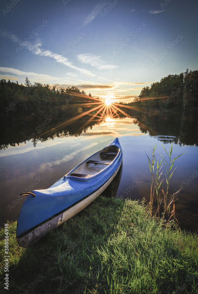 canoe on lake and sunset