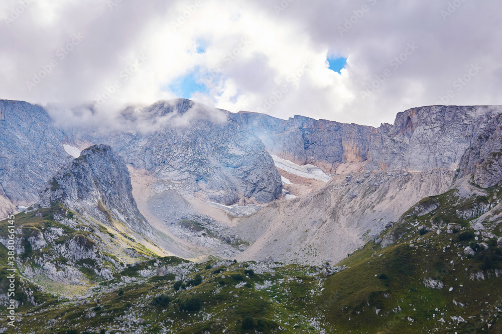 mountain cirque (bowl-shaped valley) with melting glaciers and alpine meadows in the foreground; Mount Fisht, Caucasus