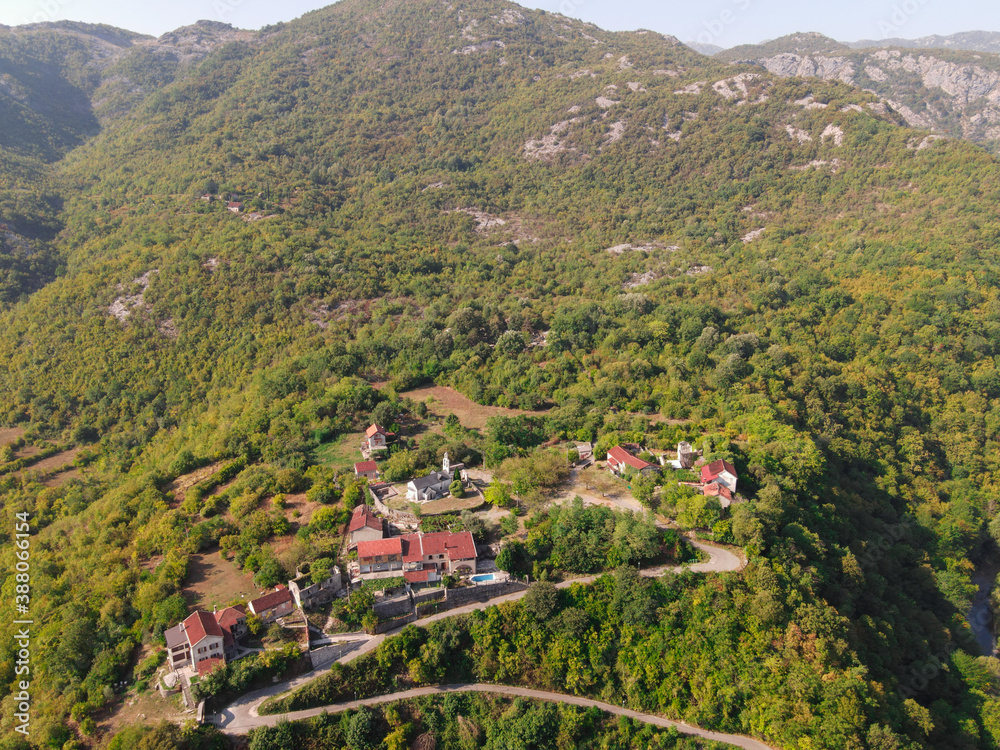 village in the mountains with trees. Aerial landscape