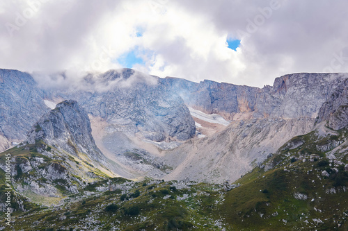 Fototapeta Naklejka Na Ścianę i Meble -  mountain cirque (bowl-shaped valley) with melting glaciers and alpine meadows in the foreground; Mount Fisht, Caucasus