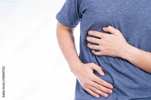 Man hand touching stomach, waist, or liver position isolated white background. Health care and medical concept.