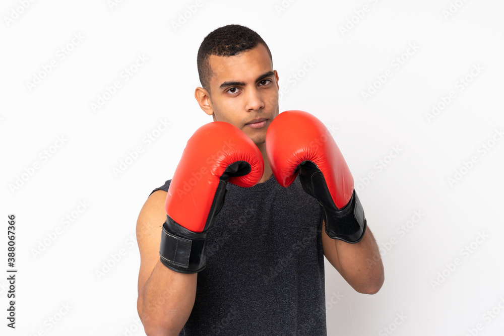 Young African American sport man over isolated white background with boxing gloves Young African American sport man over isolated white background with boxing gloves