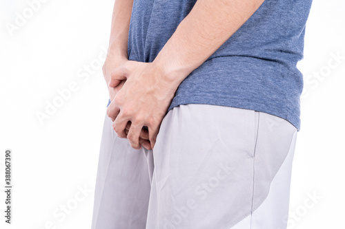 Man hands holding his crotch isolated white background. Medical, healthcare for advertising concept. photo
