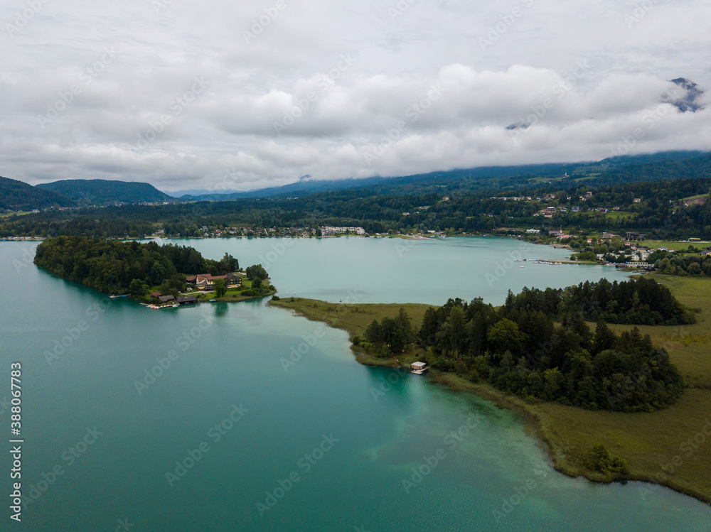 Naklejka premium Aerial view on Lake 'Faaker See' in Carinthia (Kaernten), Austria with its famous turquoise water on a cloudy summer day