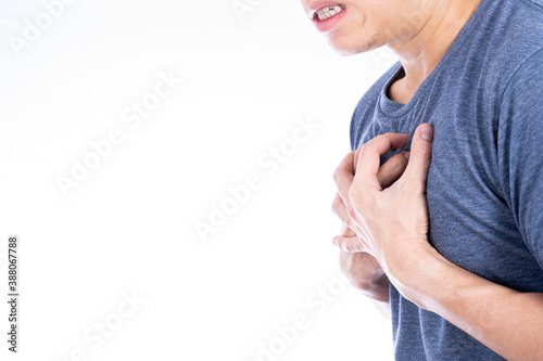 Man touching his heart or chest isolated white background. Healthcare medical or daily life concept.