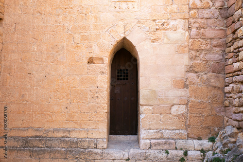 Old wood door from a medieval town in Spain. © Leckerstudio