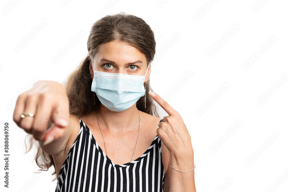 Woman pointing index finger at disposable mask and camera screen Woman pointing index finger at disposable mask and camera screen