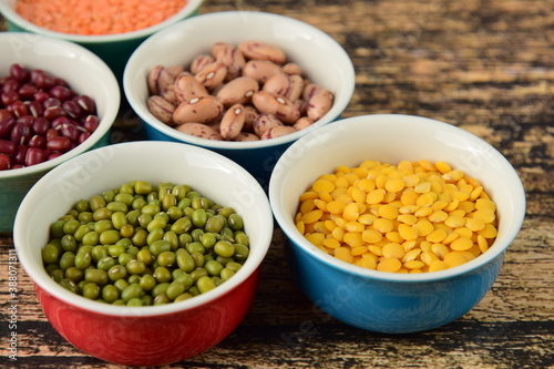 Assorted Legumes: beans and lentils variety on wooden background