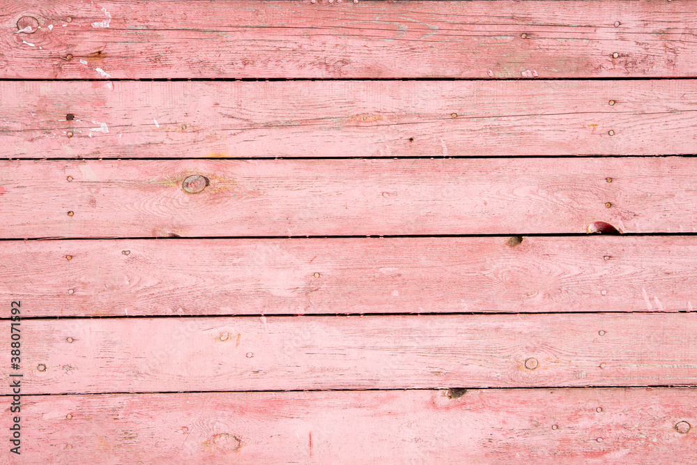 Naklejka premium Background from horizontally arranged pink boards, wood texture with copy space