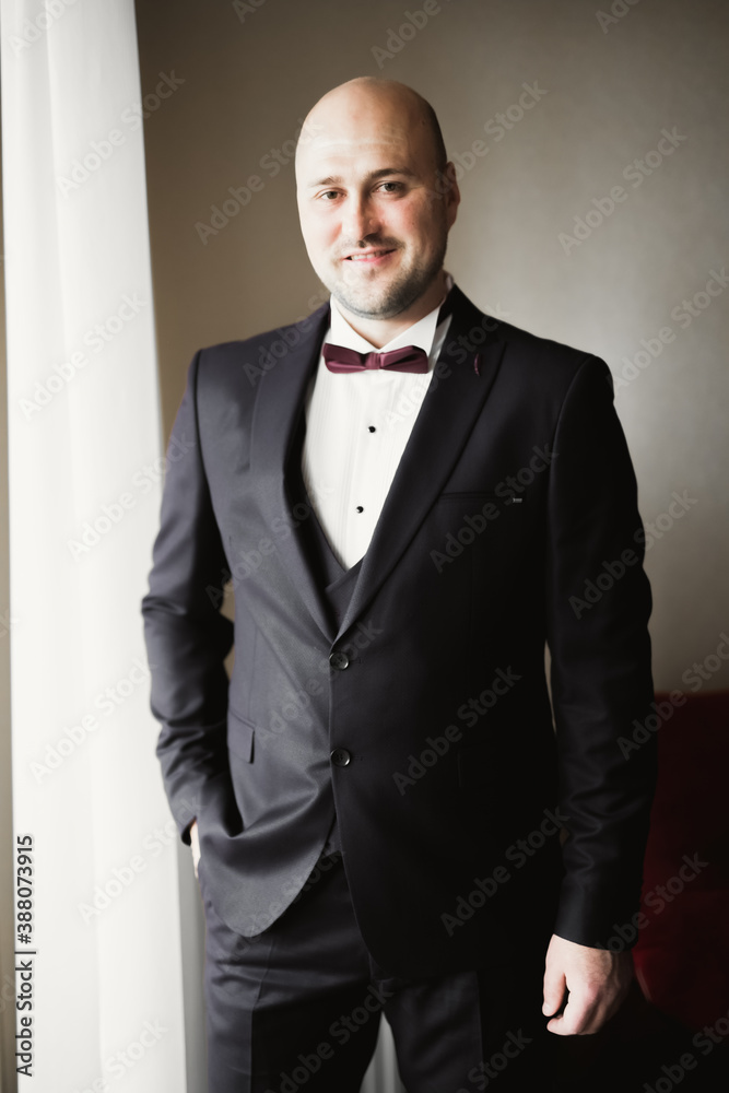 Beautiful man, groom posing and preparing for wedding Beautiful man, groom posing and preparing for wedding