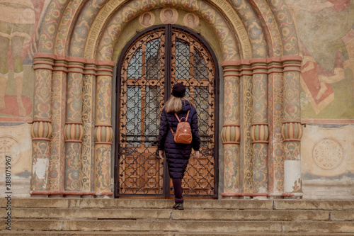 a girl stands in front of a Church