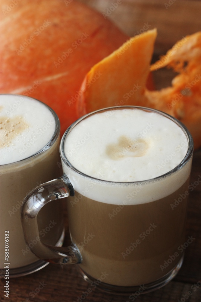 Pumpkin latte on a wooden table macro Pumpkin latte on a wooden table macro
