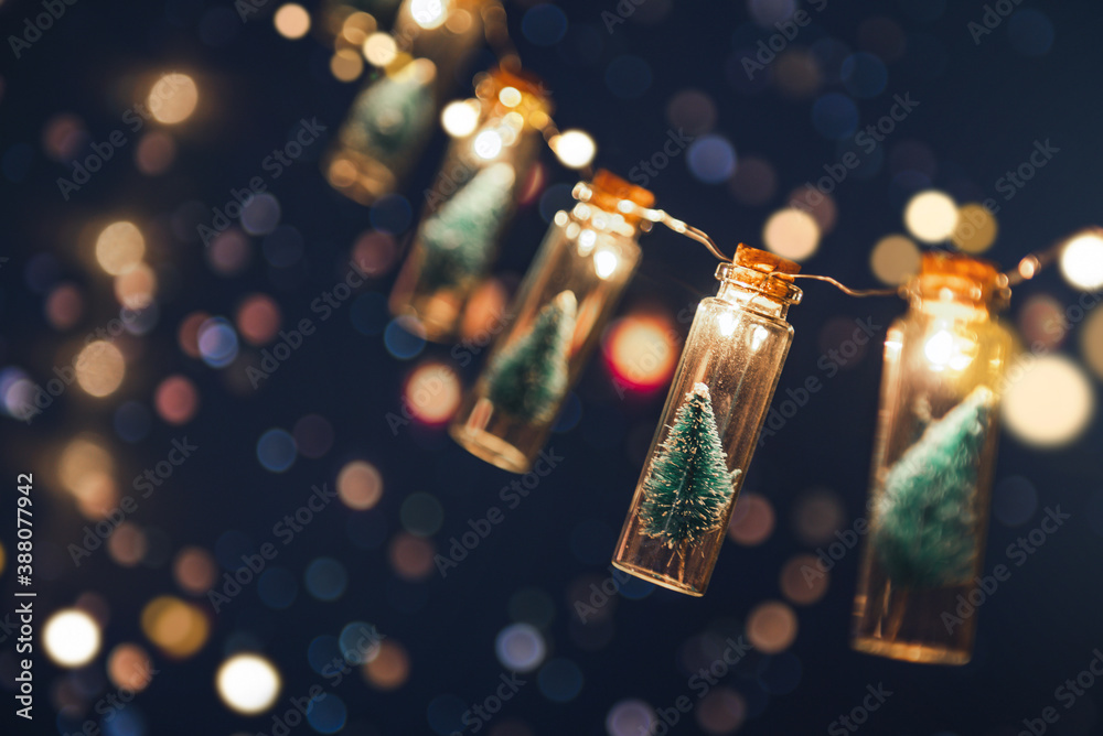 Christmas and new year concept, Close-up, Elegant Christmas tree in glass jar with bokeh lights background, copy space. - obrazy, fototapety, plakaty 