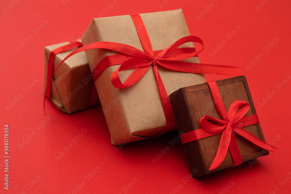 Christmas gifts in boxes tied with red ribbons, isolated on red background Christmas gifts in boxes tied with red ribbons, isolated on red background
