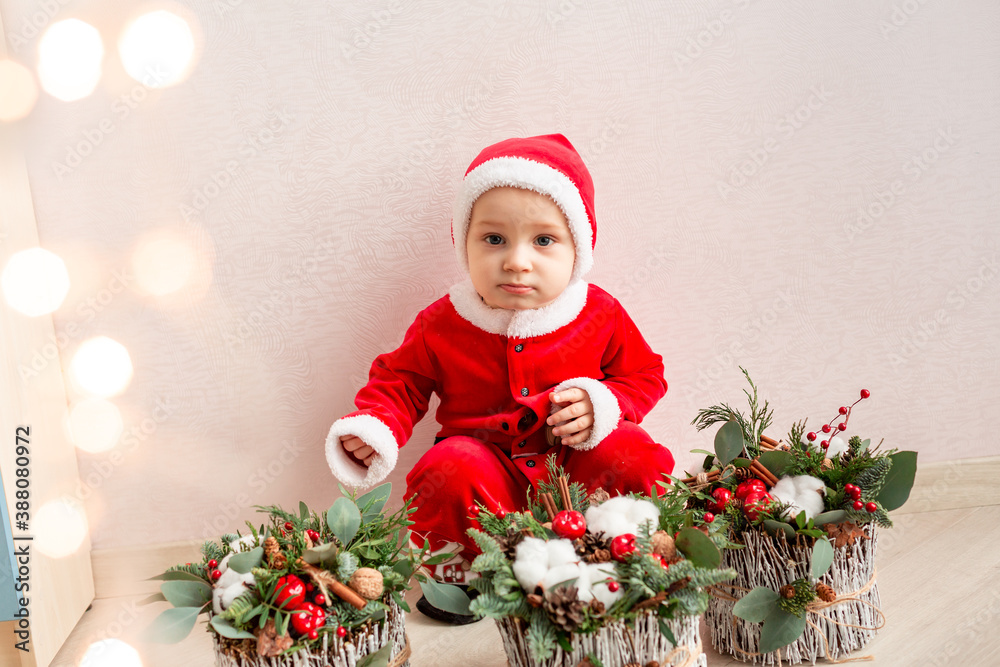 Cute small Santa Claus with Christmas flower decoration. Cute small Santa Claus with Christmas flower decoration.