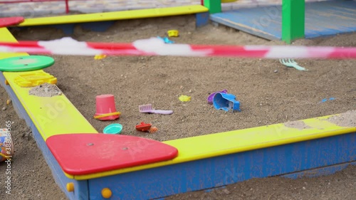 Wallpaper Mural Abandoned, forgotten colored children toys, buckets, scoops in closed playground close up. No entrance to sandbox during quarantine period outdoor. Social distance and isolation concept. Pandemic time Torontodigital.ca