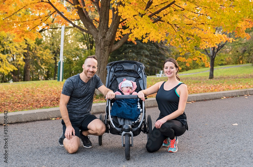 A jogging couple with stoller on autumn season photo