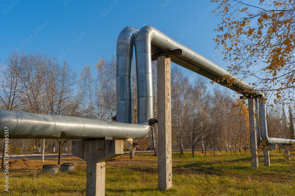 City heat line that conducts heat to residential buildings. Central heating in Russia. Insulated pipe with insulation and aluminum coating City heat line that conducts heat to residential buildings. Central heating in Russia. Insulated pipe with insulation and aluminum coating