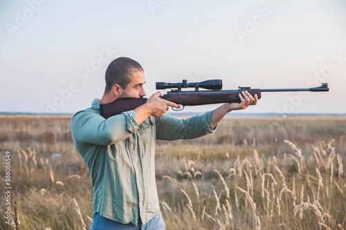 Hunter aim in the field with a sniper rifle
