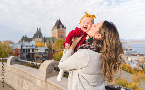 Baby daughter and her mother in the autumn season in park