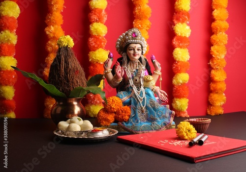 Lakshmi pujan - godess laxmi idol, Copper Kalash, coconut with Red accounting note book and haldi kumkum photo