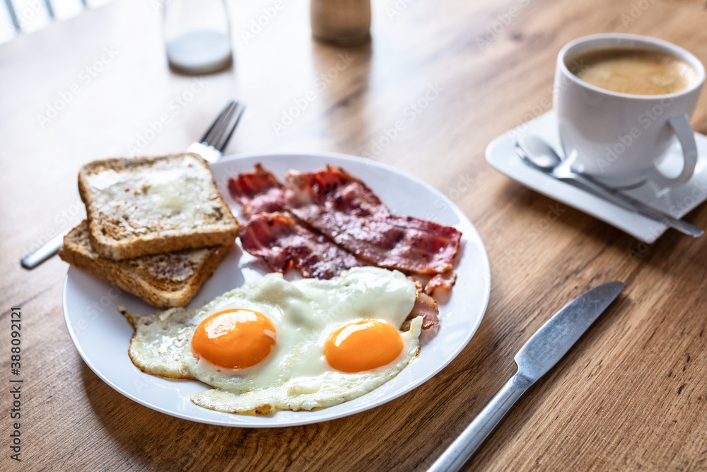 Tasty breakfast with two eggs, bacon, toasts and coffee Tasty breakfast with two eggs, bacon, toasts and coffee