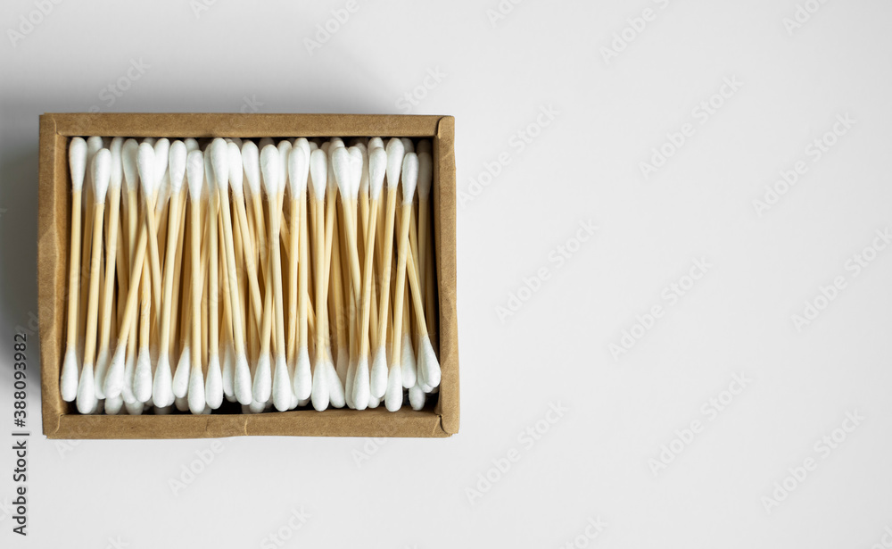 Eco-friendly cotton swabs. A cardboard box containing recyclable bamboo cotton buds on a gray surface. Zero waste concept. Eco product. Cosmetic sticks in a box. Wooden sticks for cleaning ears. Eco-friendly cotton swabs. A cardboard box containing recyclable bamboo cotton buds on a gray surface. Zero waste concept. Eco product. Cosmetic sticks in a box. Wooden sticks for cleaning ears.