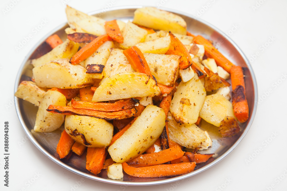 plate with freshly baked potatoes with carrots on white plate with freshly baked potatoes with carrots on white