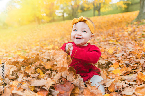 happy playful child girl outdoors in autumn season