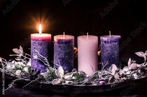one burning candle on advent wreath