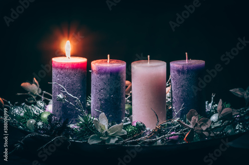 one burning candle on advent wreath photo