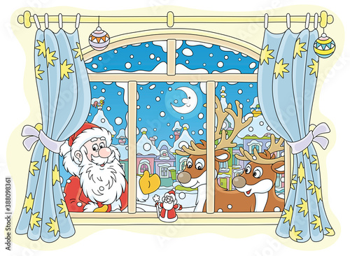 Santa Claus and his magic reindeer peeping into a room through a window with curtains on the snowy night before Christmas in a snow-covered small town, vector cartoon illustration
